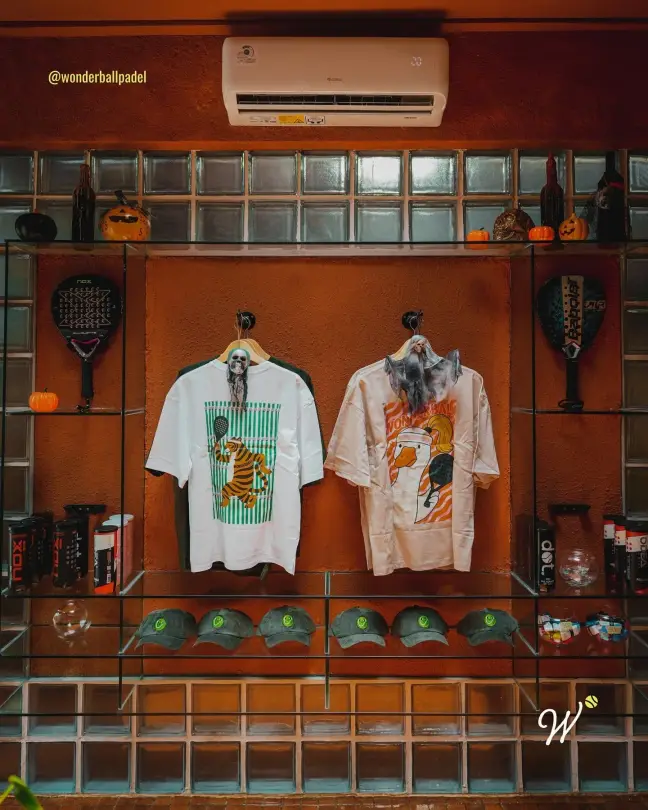 Merch shirts and caps on display