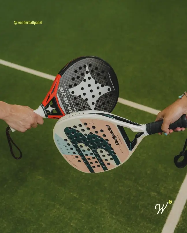 Two rackets meeting over the turf